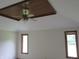 Bedroom with a tray ceiling, decorative fan, and natural light from two windows at 4288 Silver Hill Dr, Greenwood, IN 46142