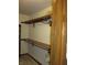 A walk-in closet with wood shelving and neutral carpet and walls at 4288 Silver Hill Dr, Greenwood, IN 46142