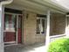 Inviting front entry featuring a stained glass door and storm door, brick wall and an open porch at 4288 Silver Hill Dr, Greenwood, IN 46142