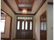 Grand foyer with wood trim details and a decorative ceiling, leading into the home at 4288 Silver Hill Dr, Greenwood, IN 46142
