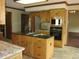 Kitchen boasting stainless steel appliances, an island with cooktop, and wood cabinets at 4288 Silver Hill Dr, Greenwood, IN 46142