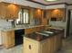 Kitchen featuring an island, granite countertops, and light wood cabinets at 4288 Silver Hill Dr, Greenwood, IN 46142