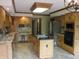 Spacious kitchen with a center island, stainless steel appliances, desk area, and wooden cabinetry at 4288 Silver Hill Dr, Greenwood, IN 46142