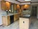 Traditional kitchen featuring wood cabinetry, granite counters, and an island with black countertop at 4288 Silver Hill Dr, Greenwood, IN 46142