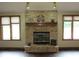 Cozy living room features a brick fireplace flanked by windows for a warm and inviting atmosphere at 4288 Silver Hill Dr, Greenwood, IN 46142