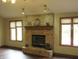 Cozy living room features a brick fireplace flanked by windows for a warm and inviting atmosphere at 4288 Silver Hill Dr, Greenwood, IN 46142