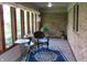 Cozy sunroom with brick accents, large windows, and a decorative rug, perfect for relaxation at 4288 Silver Hill Dr, Greenwood, IN 46142