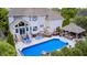 Stunning aerial view of backyard with a beautiful in-ground pool, plenty of patio furniture, and a gazebo at 434 Sheffield Ct, Carmel, IN 46032