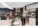 Basement bar area with black countertop and white cabinets with mirrored backsplash for drink preparation at 434 Sheffield Ct, Carmel, IN 46032