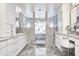 Contemporary primary bathroom featuring marble countertops, double sinks, and a walk-in shower at 434 Sheffield Ct, Carmel, IN 46032