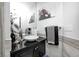 Stylish bathroom with a black vanity, vessel sink, modern fixtures, and striking monkey artwork on the walls at 434 Sheffield Ct, Carmel, IN 46032