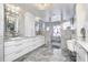 Elegant primary bathroom featuring marble countertops, double sinks, custom tile, and stylish fixtures at 434 Sheffield Ct, Carmel, IN 46032