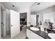 Bright bathroom featuring granite countertop, white cabinets, and open view to the cozy and well-lit bedroom at 434 Sheffield Ct, Carmel, IN 46032