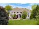 Stunning brick home with mature landscaping, lush green lawn, and classic architectural details at 434 Sheffield Ct, Carmel, IN 46032