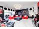 Open-concept living room with a red sectional sofa and modern black and white accents at 434 Sheffield Ct, Carmel, IN 46032