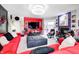 Spacious living area with a bright red sofa and eclectic decor accents at 434 Sheffield Ct, Carmel, IN 46032
