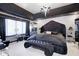 Luxurious primary bedroom featuring a unique headboard, chandelier, and elegant decor at 434 Sheffield Ct, Carmel, IN 46032