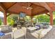 Luxurious outdoor pavilion featuring a fireplace, TV, ceiling fan, and stylish seating for entertaining at 434 Sheffield Ct, Carmel, IN 46032