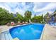 Sparkling pool with slide, basketball hoop, and lounge chairs, perfect for outdoor fun at 434 Sheffield Ct, Carmel, IN 46032