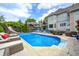 An inviting pool with a slide and backyard view, promising hours of relaxation and entertainment at 434 Sheffield Ct, Carmel, IN 46032