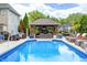 Inviting pool with a basketball hoop, slide, outdoor pavilion, and palm tree offering backyard fun at 434 Sheffield Ct, Carmel, IN 46032