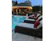 Outdoor pool with comfortable lounge chairs and a covered patio with string lights at 434 Sheffield Ct, Carmel, IN 46032