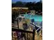 Outdoor swimming pool area with chairs, tables, gazebo and night time lighting at 434 Sheffield Ct, Carmel, IN 46032