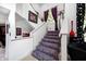 Unique staircase featuring modern decor, plush carpeting, and vibrant accents at 434 Sheffield Ct, Carmel, IN 46032