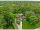 Aerial view of home with meticulously maintained lawn, mature landscaping, and lush green trees at 470 Mill Farm Rd, Noblesville, IN 46062