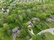 Aerial view of a beautifully landscaped property surrounded by lush green trees in a quiet neighborhood at 470 Mill Farm Rd, Noblesville, IN 46062