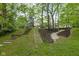 Expansive backyard featuring multiple levels, concrete steps, a stone pathway, and mature trees at 470 Mill Farm Rd, Noblesville, IN 46062