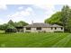 Stone home with beautifully landscaped backyard and covered outdoor seating area at 470 Mill Farm Rd, Noblesville, IN 46062