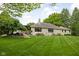 Stunning stone home with mature landscaping, large yard, and outdoor patio at 470 Mill Farm Rd, Noblesville, IN 46062
