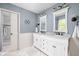 Bathroom featuring double vanity, white cabinets, and marble tiled shower at 470 Mill Farm Rd, Noblesville, IN 46062
