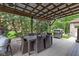 Outdoor kitchen and dining area with covered patio and ceiling fan at 470 Mill Farm Rd, Noblesville, IN 46062
