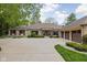 Beautiful stone home showcasing a large driveway, three-car garage, and professional landscaping at 470 Mill Farm Rd, Noblesville, IN 46062