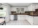 Cozy kitchen with white cabinets, black countertop, and stainless steel dishwasher at 470 Mill Farm Rd, Noblesville, IN 46062