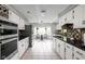 Spacious kitchen featuring white cabinets, dark countertops, and stainless steel appliances at 470 Mill Farm Rd, Noblesville, IN 46062