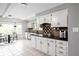 Bright kitchen featuring white cabinets, granite countertops, and a cozy breakfast nook at 470 Mill Farm Rd, Noblesville, IN 46062