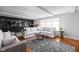 Spacious living room with a large white sectional sofa, hardwood floors, and neutral decor at 470 Mill Farm Rd, Noblesville, IN 46062