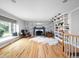 Bright living room with built-in shelving, fireplace, and large window seat at 470 Mill Farm Rd, Noblesville, IN 46062
