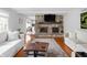 Cozy living room with a stone fireplace, hardwood floors, and natural light at 470 Mill Farm Rd, Noblesville, IN 46062