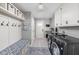 Mudroom boasts storage cubbies, coat hooks, and front-loading washer and dryer at 470 Mill Farm Rd, Noblesville, IN 46062