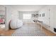 Bright playroom with large beanbag chairs, a patterned rug, and a table for activities at 470 Mill Farm Rd, Noblesville, IN 46062