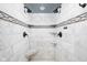 Luxurious marble shower with dual shower heads and built-in shelves at 470 Mill Farm Rd, Noblesville, IN 46062