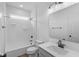 Bright bathroom featuring a shower-tub combo, white vanity with quartz countertop and dark fixtures at 5032 Carmine St, Brownsburg, IN 46112