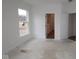 A bedroom with a window overlooking the front yard and a door to the bathroom at 5032 Carmine St, Brownsburg, IN 46112