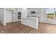 Modern kitchen with white cabinets, stainless steel appliances, a kitchen island and a large window at 5032 Carmine St, Brownsburg, IN 46112