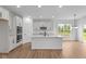 Clean kitchen featuring white cabinets, stainless steel appliances, a center island, and a view of the outdoors at 5032 Carmine St, Brownsburg, IN 46112