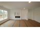 Bright living room featuring a sleek modern fireplace and large windows at 5032 Carmine St, Brownsburg, IN 46112